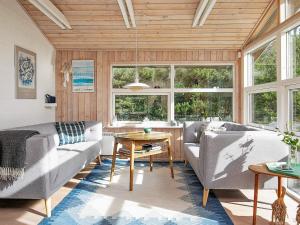 a living room with two couches and a table at 5 person holiday home in Jerup-By Traum in Jerup