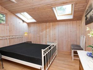a bedroom with a bed in a room with skylights at 5 person holiday home in Jerup in Jerup