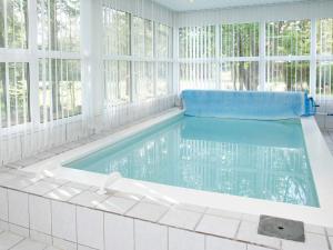 a swimming pool in a room with windows at 8 person holiday home in Hals-By Traum in Hals