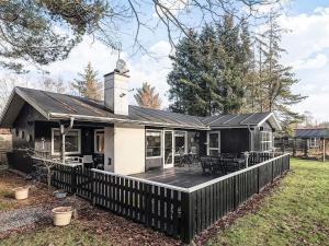 a house with a deck and a fence at 8 person holiday home in Hals-By Traum in Hals +40 photos