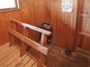 a room with a bed in a wooden cabin at 6 person holiday home in Rudkøbing in Spodsbjerg