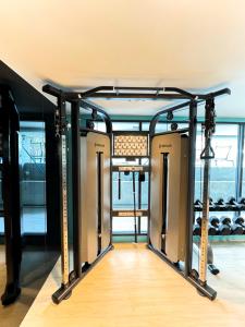 a gym with two rows of equipment in a room at New Stylish Cozy Condo in Phuket in Ban Thalat Choeng Thale