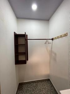 a room with a shower with a towel on the wall at Casa Menta in San Juan del Sur +1 photo