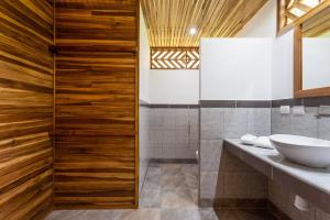 a bathroom with a sink and a mirror at Relax Natural Village Adults Only in Puerto Viejo