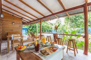 een tafel met eten op een patio bij Relax Natural Village Adults Only in Puerto Viejo