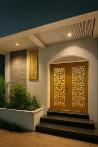 a front door of a house with stairs at Hotel Sindur in Ujjain