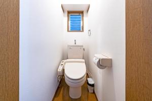 a small bathroom with a toilet with a window at IL Regalo Tenjin Street Stay in Fukuoka +25 photos