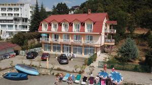 a large house with a red roof and a parking lot at Villa Cvet Rooms in Ohrid