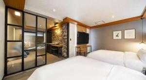 a hotel room with two beds and a television at No 25 Hotel Songtan in Pyeongtaek