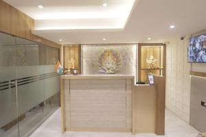 a room with a counter with a painting on the wall at Hotel Malad Inn opposite Malad Railway Station in Mumbai