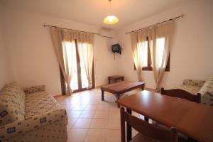 a living room with a couch and a table and chairs at Eden Apartments in Neo Klima