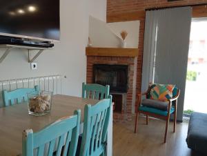 a dining room with a table and chairs and a fireplace at La Casita de Suances 2 - a 5 min de la Playa, Ideal Familias y Mascotas in Suances