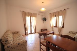 a living room with a couch and a table at Eden Apartments in Neo Klima