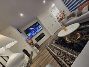 a living room with a sink and a tv at Modern Comfort - With AC in Calgary