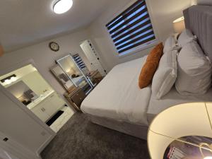 a bedroom with a large bed and a mirror at Modern Comfort - With AC in Calgary