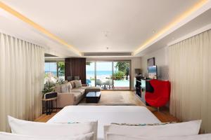 a bedroom with two beds and a living room at Double - Six, Luxury Hotel - Seminyak in Seminyak