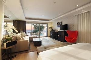 a hotel room with a bed and a living room at Double - Six, Luxury Hotel - Seminyak in Seminyak
