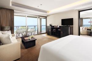 a hotel room with a bed and a living room at Double - Six, Luxury Hotel - Seminyak in Seminyak