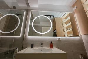 a bathroom with a sink and a mirror at Nido Uno Brașov in Braşov +16 photos