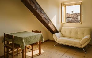 a living room with a table and a couch and a window at Angolo center in Turin