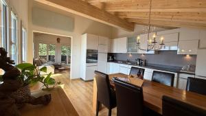 a kitchen with a wooden table and a dining room at am Bärgbach DG in Bettmeralp