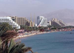 a view of a beach with hotels and buildings at Eden Suite in Eilat