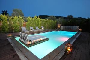 a swimming pool with lounge chairs at Byblos Luxury Villa in Prinos