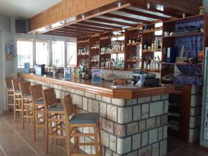 a bar with a bunch of chairs around it at Albatross Studios in Kefalos