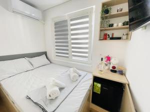 a small bedroom with a bed with towels on it at The Secret Tale in Varna City