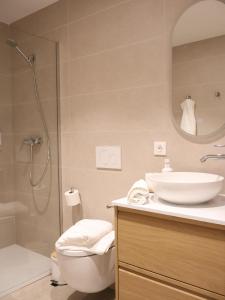 a bathroom with a toilet and a sink and a shower at Apartamento Larrabide Boho Chic in Pamplona
