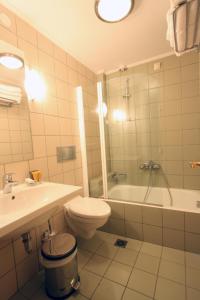 a bathroom with a toilet and a sink and a tub at Hotel Papanastasiou in Elati Trikalon