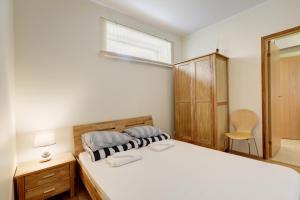 a bedroom with a bed and a window and a mirror at Hommiku 8a Apartment in Pärnu