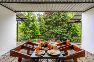 a table with food on it on a patio at Interlaken - 4 BR VIlla in Yedapalli