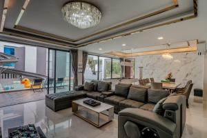 a living room with a couch and a table at Villa Aftersol Cha-Am in Cha Am