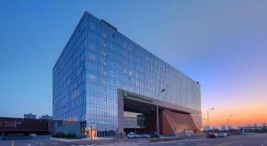 a large glass office building with a parking lot at Holiday Inn Express Handan East By IHG in Handan