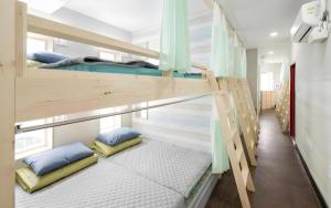 a couple of bunk beds in a room at Capsule Inn Gangneung in Gangneung
