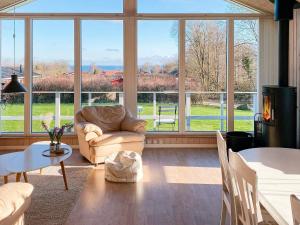 a living room with a couch and a large window at 6 person holiday home in Sydals in Sarup
