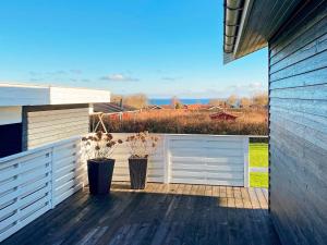a deck with two potted plants on a house at 6 person holiday home in Sydals in Sarup
