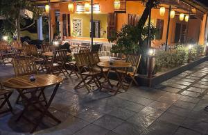 a group of tables and chairs in front of a restaurant at PUN Retreat in Quy Nhon