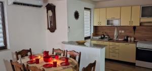 a kitchen with a table with red candles on it at Peja Urban Stay in Peje
