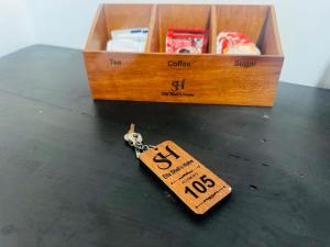 a small tag on a table next to a box at Ella Shali's home in Ella