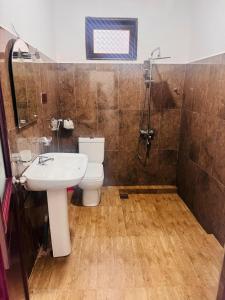 a bathroom with a toilet and a sink and a shower at Ella Shali's home in Ella +62 photos