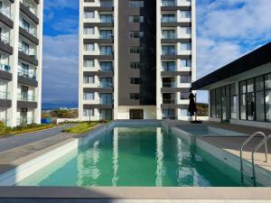a swimming pool in front of a building at TheEJResidence- 2Bedroom All Ensuite- 7km from JKIA 3km from SGR and Expressway along Mombasa Road-Nairobi Kenya in Nairobi