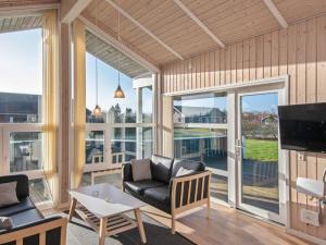 a living room with a couch and a tv at 6 person holiday home in Tarm in Tarm +24 photos