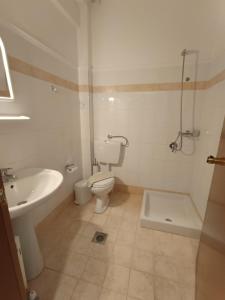 a bathroom with a toilet and a sink and a shower at Stavros Beach Hotel in Stavros +172 photos