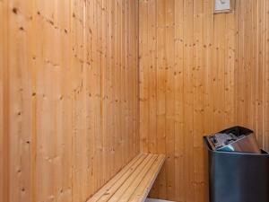 a wooden room with a bench and a trash can at 4 star holiday home in Tarm in Tarm
