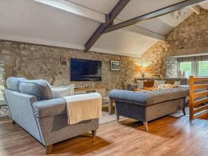 a living room with two couches and a couch at Kilnsey Wellbeing Barn With Hot Tub, Cold Plunge, Pet Friendly in Kilnsey