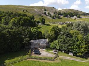 an aerial view of a house with a car parked in a field at Kilnsey Wellbeing Barn With Hot Tub, Cold Plunge, Pet Friendly in Kilnsey
