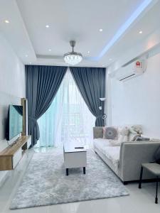 un salon avec un canapé et une télévision dans l'établissement SUZEN Homestay Sri Indah, à Sandakan 8 autres photos