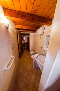 a bathroom with two toilets and two sinks in it at Il Rudere in Gonnesa